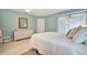 Serene bedroom with white bedding, dresser, and access to a balcony at 2810 51St W Ave, Bradenton, FL 34207