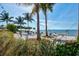 Relaxing beach scene with hammocks, palm trees, and waterfront views at 322 Compass Point Dr # 201, Bradenton, FL 34209