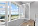 Bedroom window featuring open shutters to water views at 326 Compass Point Dr # 201, Bradenton, FL 34209