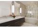 Spa-like bathroom with a freestanding tub, double vanity, and marble floors at 33 S Palm Ave # 1601, Sarasota, FL 34236