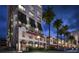 Luxury building exterior at night, featuring Spanish-style architecture and palm trees at 33 S Palm Ave # 1601, Sarasota, FL 34236