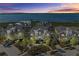 Sunset view of an attractive waterfront community, boasting lush greenery and stunning bay vistas at 330 Compass Point Dr # 101, Bradenton, FL 34209