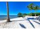 Relaxing beachfront with white sand and comfy lounge chairs at 330 Compass Point Dr # 101, Bradenton, FL 34209