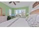 Bright bedroom with king-size bed,plant, and water view at 330 Compass Point Dr # 101, Bradenton, FL 34209