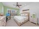 Green bedroom with a king-size bed and plenty of natural light at 330 Compass Point Dr # 101, Bradenton, FL 34209