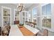 Bright dining room with a farmhouse table, chairs, and plantation shutters on the windows at 330 Compass Point Dr # 101, Bradenton, FL 34209