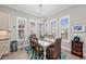 Bright dining room features a table with chairs, and large windows with plantation shutters at 330 Compass Point Dr # 101, Bradenton, FL 34209