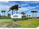 The Beach Club entrance sign with palm trees at 330 Compass Point Dr # 101, Bradenton, FL 34209