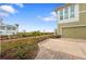 Tan house with garage and paved driveway, water view at 330 Compass Point Dr # 101, Bradenton, FL 34209