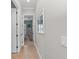 Light and airy hallway with tile flooring leads to bedrooms at 330 Compass Point Dr # 101, Bradenton, FL 34209
