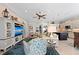 Bright living room features a comfy sofa and chairs, large TV, and an open floor plan at 330 Compass Point Dr # 101, Bradenton, FL 34209