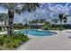 Relaxing kidney-shaped pool with lush landscaping at 330 Compass Point Dr # 101, Bradenton, FL 34209