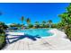 Inviting resort-style pool with ample lounge chairs and palm trees at 330 Compass Point Dr # 101, Bradenton, FL 34209