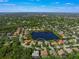 Wide aerial view showing home's location within a peaceful lake community at 4790 Sweetshade Dr, Sarasota, FL 34241