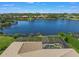 Aerial view of the house and backyard pool area overlooking the lake at 4790 Sweetshade Dr, Sarasota, FL 34241