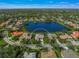 Single-Gathering home on a lake with a large backyard, situated in a quiet residential community at 4790 Sweetshade Dr, Sarasota, FL 34241