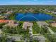 Stunning aerial view showcasing home's location on a tranquil lake at 4790 Sweetshade Dr, Sarasota, FL 34241