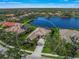 Birds-eye view of the house and surrounding neighborhood with a lake at 4790 Sweetshade Dr, Sarasota, FL 34241