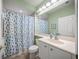 Small bathroom with shower/tub combo and seashell-themed curtain at 4790 Sweetshade Dr, Sarasota, FL 34241