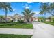 Single-story home with red front door and well-maintained landscaping at 4790 Sweetshade Dr, Sarasota, FL 34241