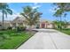 House exterior showcasing a two-car garage and a manicured lawn at 4790 Sweetshade Dr, Sarasota, FL 34241