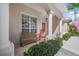 Charming front porch with rocking chair and lush landscaping at 4790 Sweetshade Dr, Sarasota, FL 34241