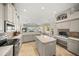 Kitchen with large island, breakfast nook, and water views at 4790 Sweetshade Dr, Sarasota, FL 34241