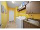 Laundry room with washer, dryer, and extra storage at 4790 Sweetshade Dr, Sarasota, FL 34241