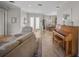 Open floor plan living room with a piano and view to dining area at 4790 Sweetshade Dr, Sarasota, FL 34241