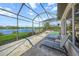 Relaxing patio with pool and lake views, perfect for outdoor entertaining at 4790 Sweetshade Dr, Sarasota, FL 34241