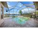 Enclosed pool and spa area with a view of the lake at 4790 Sweetshade Dr, Sarasota, FL 34241