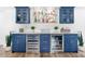 Stylish bar area with custom cabinetry, wine refrigerator, and beverage storage at 4822 Ocean Blvd # 8C, Sarasota, FL 34242