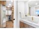 Bright bathroom featuring walk-in closet, sleek vanity with marble countertop and modern fixtures at 4822 Ocean Blvd # 8C, Sarasota, FL 34242