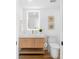 Stylish powder room featuring floating vanity, decorative seashell art, and modern lighting at 4822 Ocean Blvd # 8C, Sarasota, FL 34242