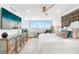 Brightly lit bedroom with hardwood floors, large window view, and TV at 4822 Ocean Blvd # 8C, Sarasota, FL 34242
