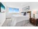 Bedroom with a large window, sleek white walls, and simple decor providing a soothing atmosphere at 4822 Ocean Blvd # 8C, Sarasota, FL 34242
