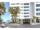 Exterior shot of the building entrance with well-maintained landscaping at 4822 Ocean Blvd # 8C, Sarasota, FL 34242