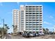 Exterior shot of the building at 4822 Ocean Blvd, a modern high-rise with ample parking, steps from the beach at 4822 Ocean Blvd # 8C, Sarasota, FL 34242