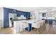 Modern kitchen featuring stainless steel appliances, quartz countertops, and custom blue cabinetry at 4822 Ocean Blvd # 8C, Sarasota, FL 34242