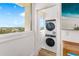 New stacked washer and dryer with views from the window at 4822 Ocean Blvd # 8C, Sarasota, FL 34242