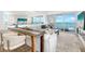 Bright living room with expansive ocean views, modern decor, and comfortable seating area at 4822 Ocean Blvd # 8C, Sarasota, FL 34242