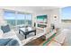 Bright living room with fireplace, balcony access, and panoramic ocean views at 4822 Ocean Blvd # 8C, Sarasota, FL 34242