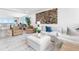 Bright living room boasts hardwood floors, chic seating, and oversized windows with stunning water views at 4822 Ocean Blvd # 8C, Sarasota, FL 34242