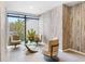 Modern lobby area with comfortable swivel chairs, tiled floors, and a view of the greenery outside at 4822 Ocean Blvd # 8C, Sarasota, FL 34242