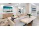 Bright lounge area with sofas, TV, tiled floor, and contemporary design, offering a comfortable space at 4822 Ocean Blvd # 8C, Sarasota, FL 34242