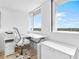 Bright office with a white desk, a printer and large windows at 4822 Ocean Blvd # 8C, Sarasota, FL 34242