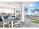 Outdoor kitchen and dining area overlooking a pool with ocean view at 4822 Ocean Blvd # 8C, Sarasota, FL 34242