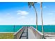 Stunning pier view with seating and direct ocean access, perfect for relaxing and enjoying waterfront living at 4822 Ocean Blvd # 8C, Sarasota, FL 34242