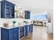 Modern wet bar features blue cabinets, a wine fridge, and ample storage with beautiful countertops at 4822 Ocean Blvd # 8C, Sarasota, FL 34242