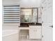Bathroom features a soaking tub, vanity with granite countertop, and updated fixtures at 5062 Flagstone Dr, Sarasota, FL 34238